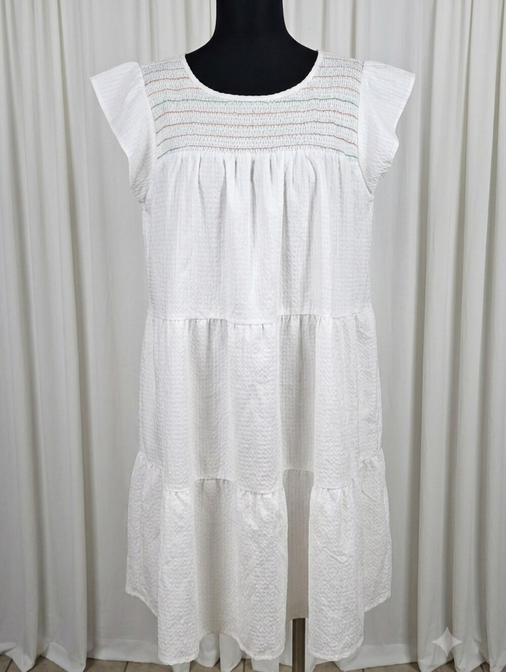 Maxwell & Geraldine "The Rose" dress with a smocked neckline and tiered design.